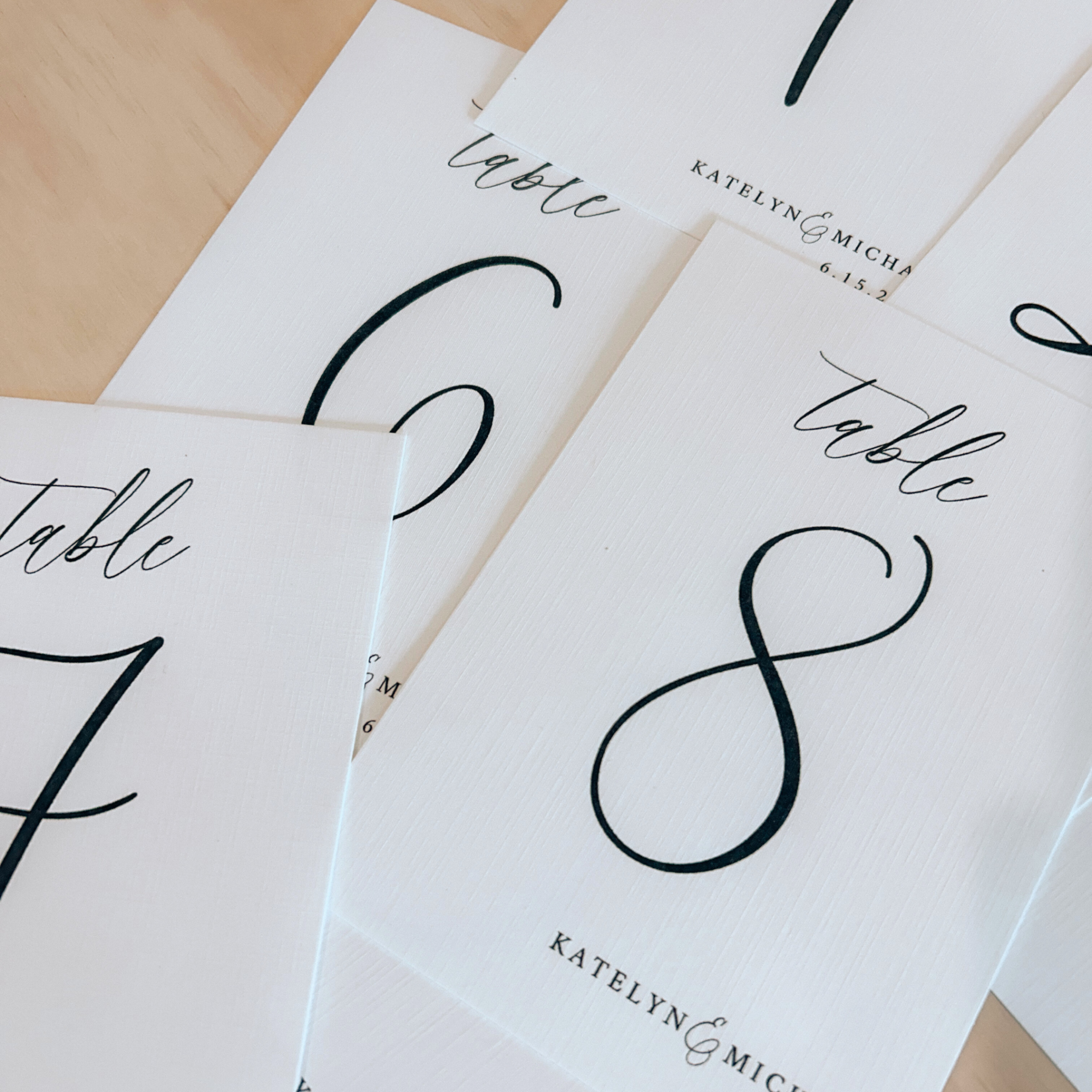 Custom linen cardstock table numbers for weddings with elegant, minimalist design.