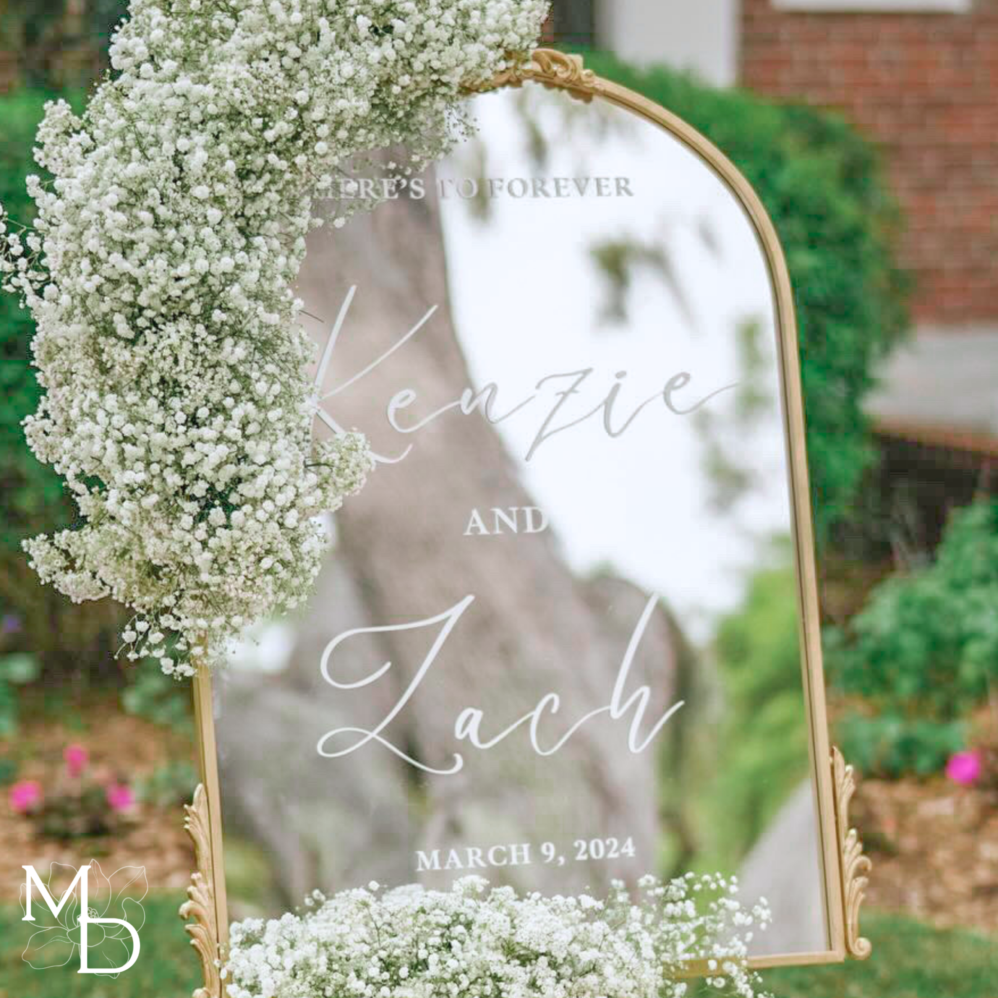 Elegant gold arch mirror wedding welcome sign with floral decoration.