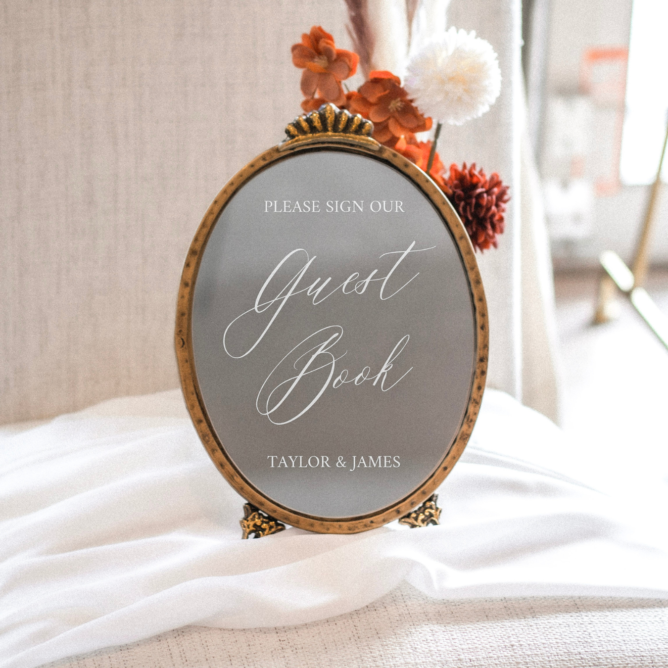 Elegant wedding mirror sign encouraging guests to sign the guest book with calligraphy font.