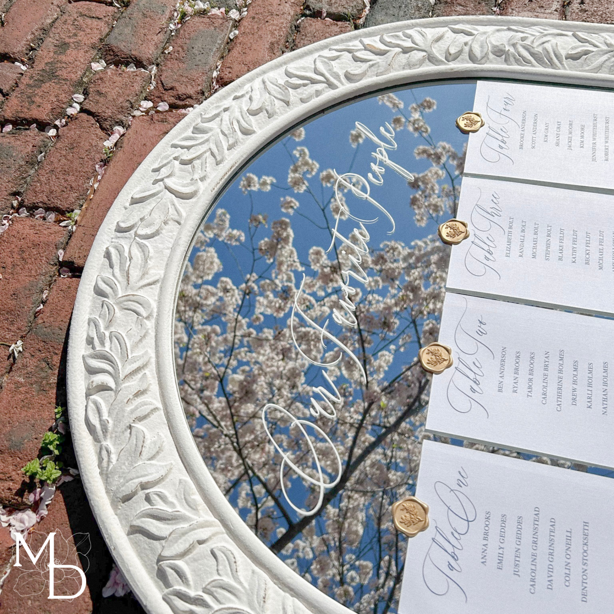 Boho large white mirror with elegant wedding guest seating chart attached using gold wax seals.