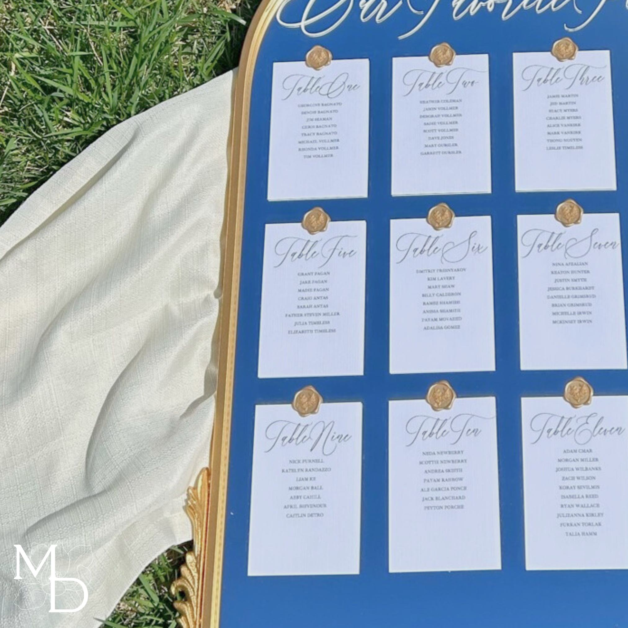 Wedding mirror seating chart with gold frame and customizable vinyl decal.