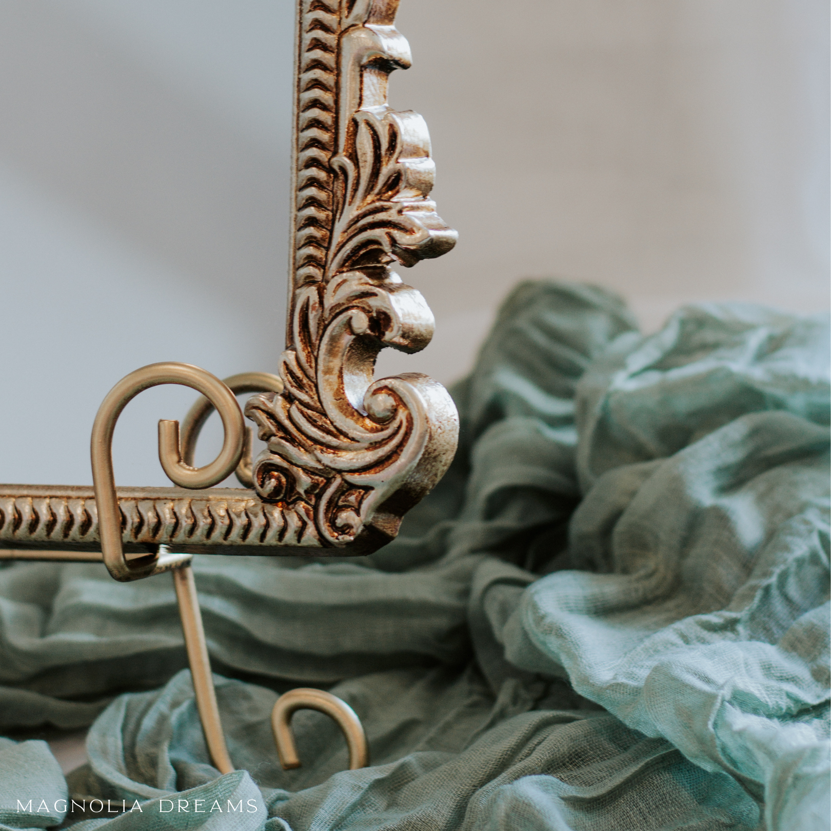 Elegant wedding guest book sign with ornate frame and green fabric background.