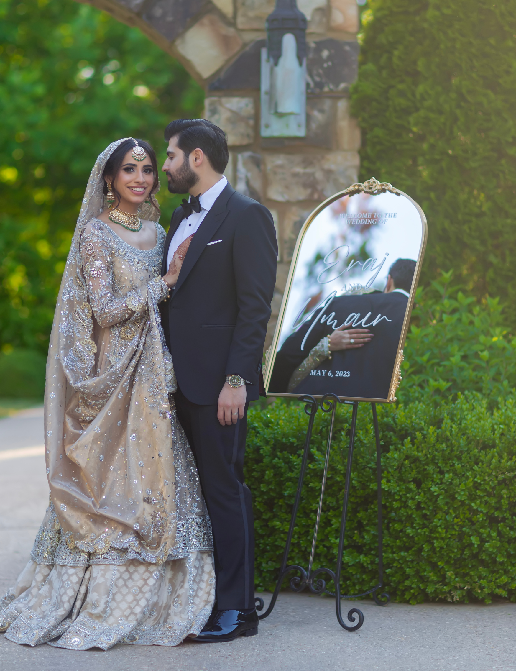 ethnic cultural indian wedding with custom gold arch mirror with jessica font printed in vinyl with the wording welcome to the wedding of