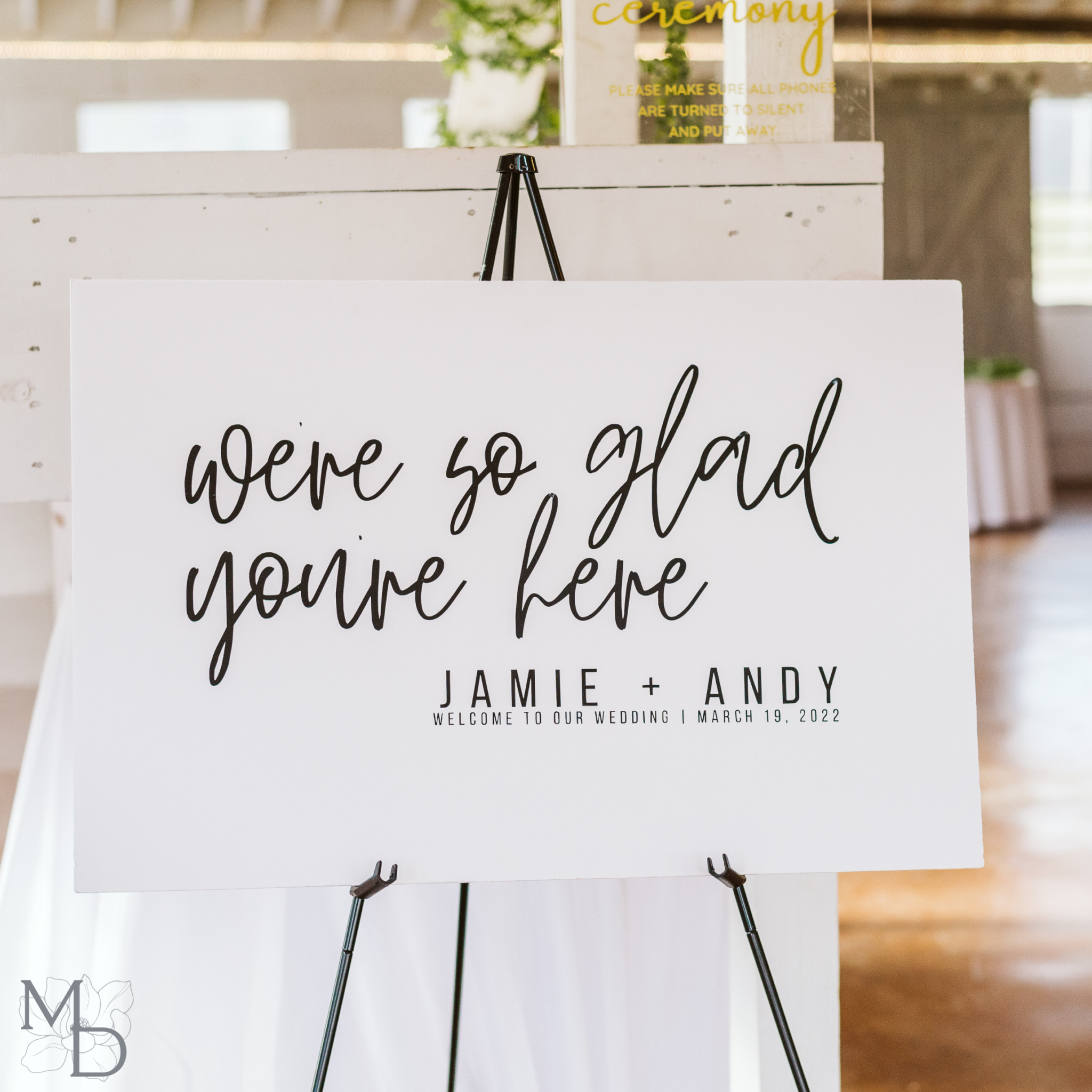 Minimalist wedding welcome sign on easel with custom fonts and design.