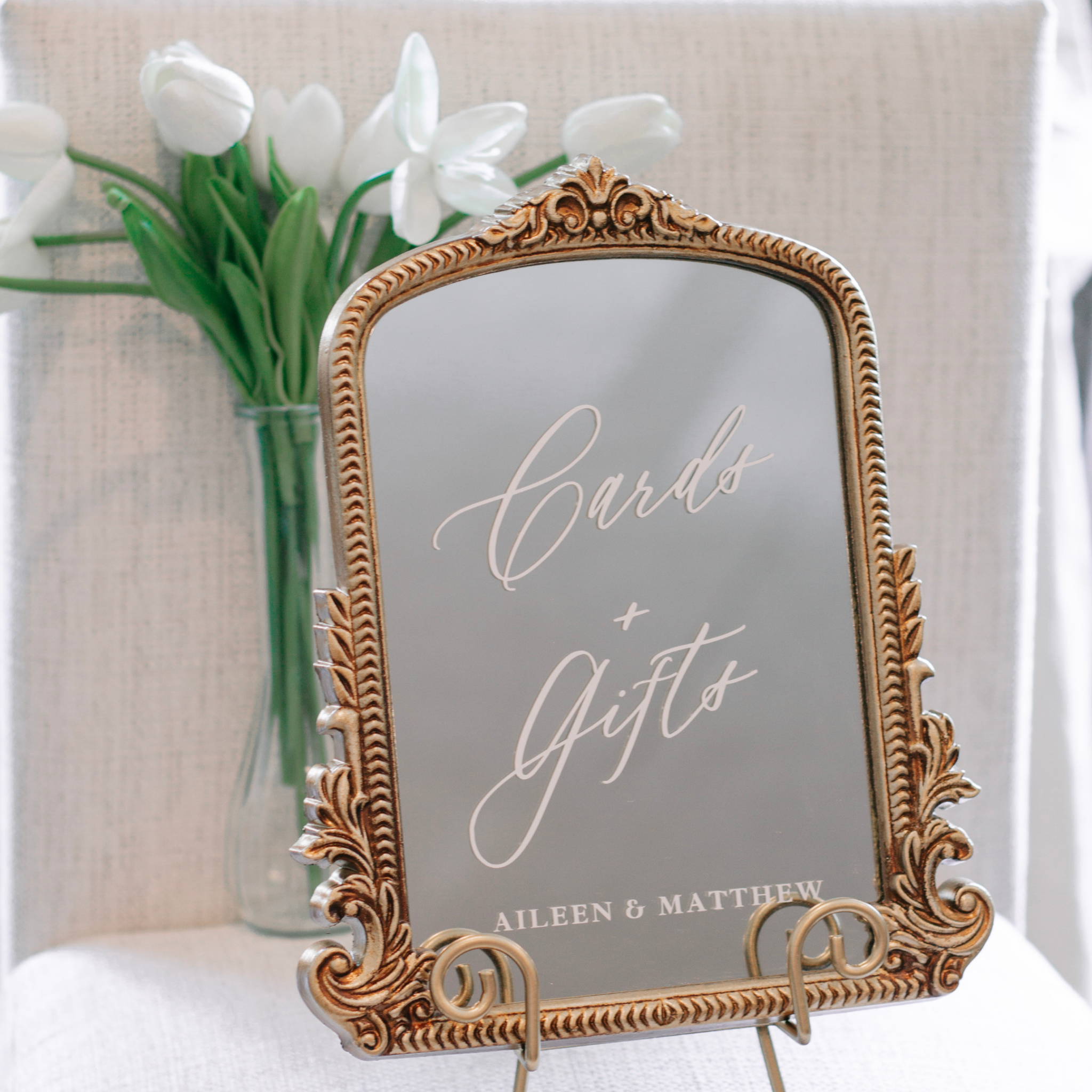 Elegant gold-framed mirror wedding sign for gifts and cards table, customizable for events.