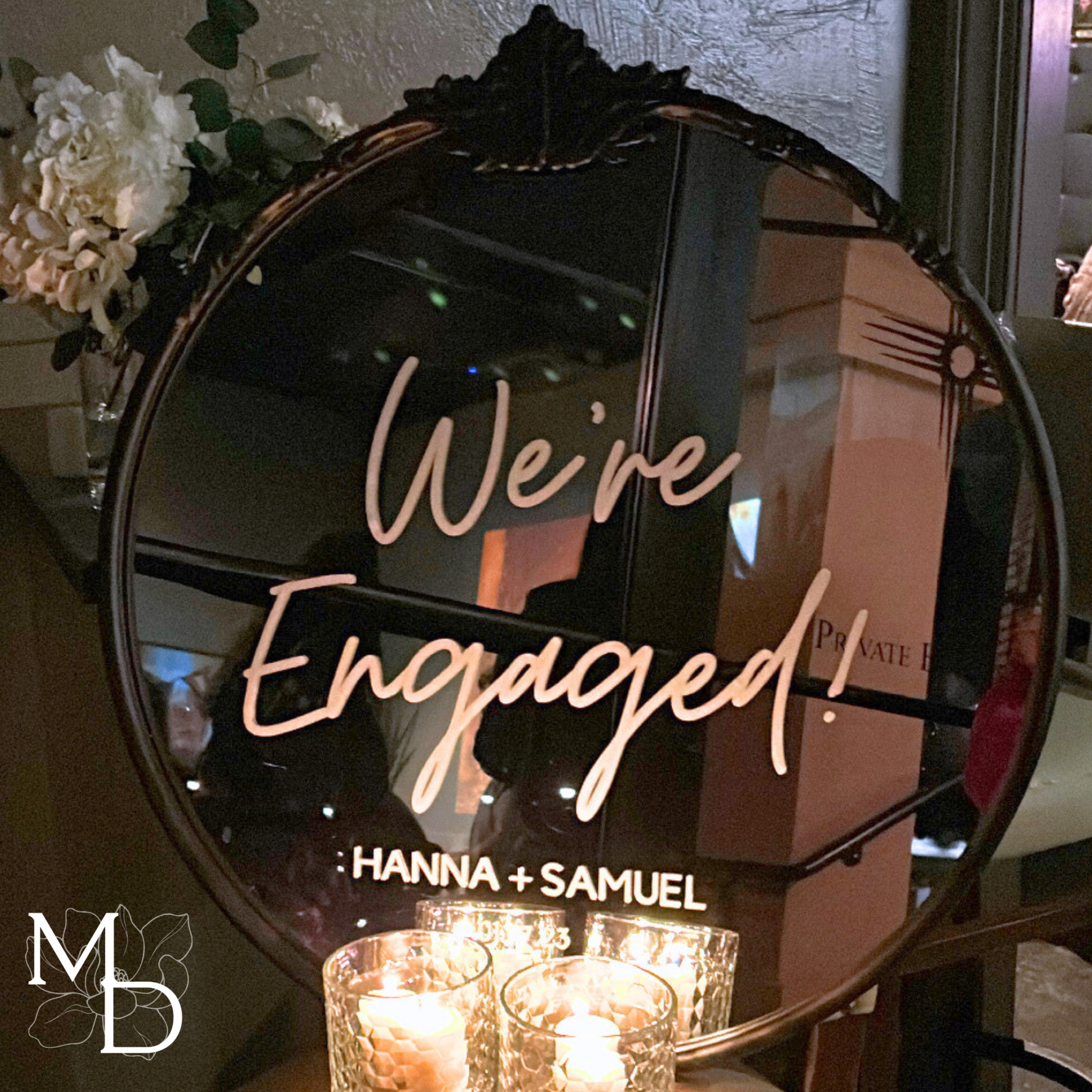 Ornate round mirror engagement party welcome sign with gold accents and customizable text.