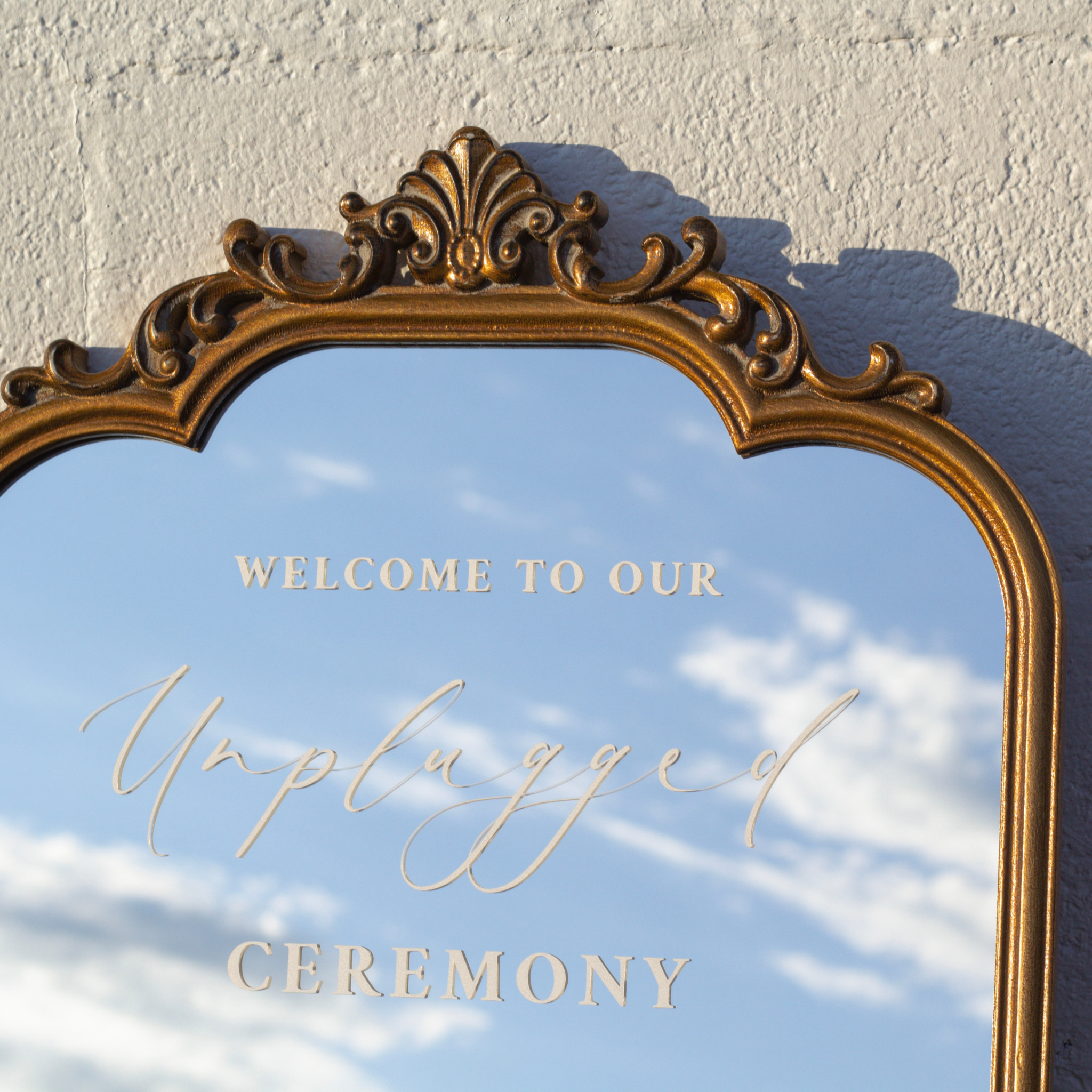 Elegant Unplugged Ceremony Sign on decorative mirror reminding wedding guests to silence phones.