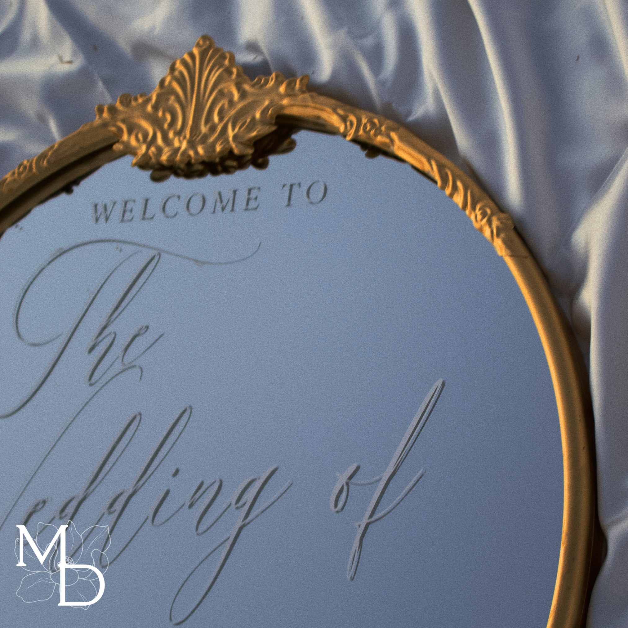 Gold ornate round mirror customized wedding welcome sign with elegant script on a golden frame.