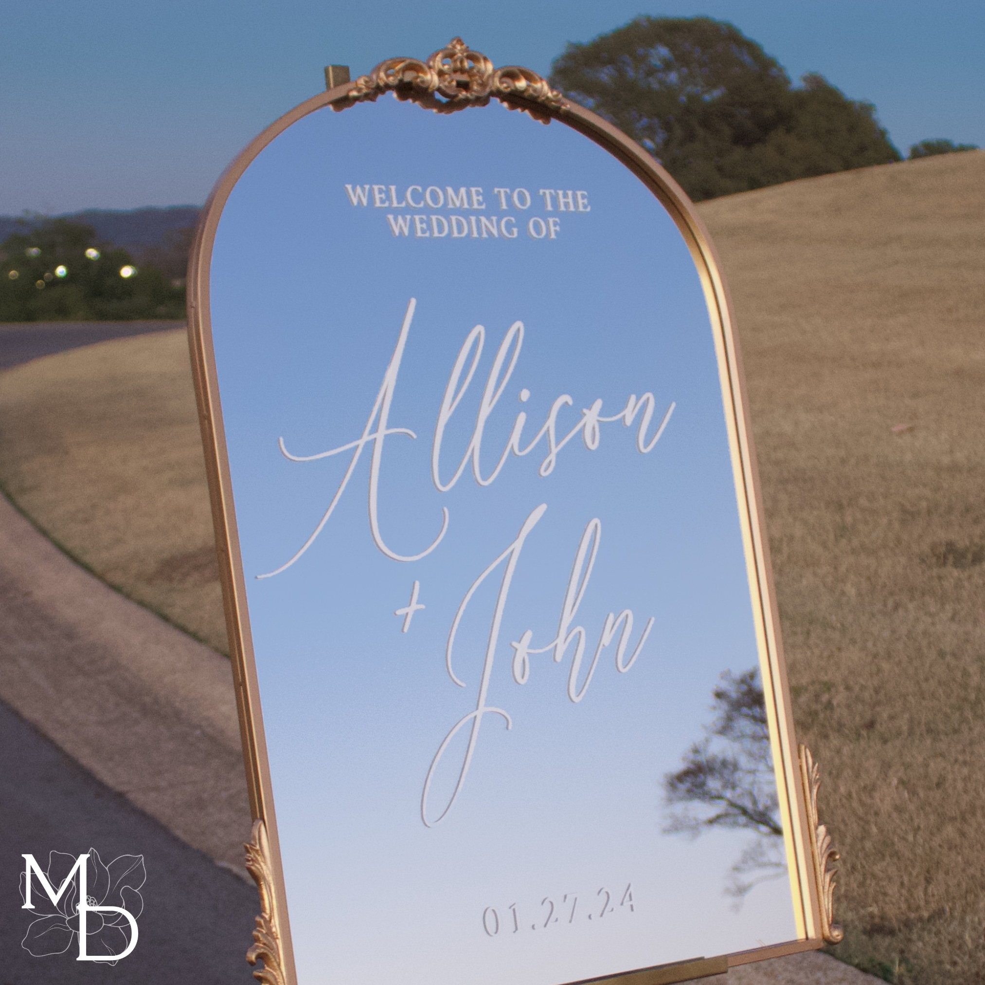 Antiqued gold arch wedding welcome mirror with custom scripted calligraphy.