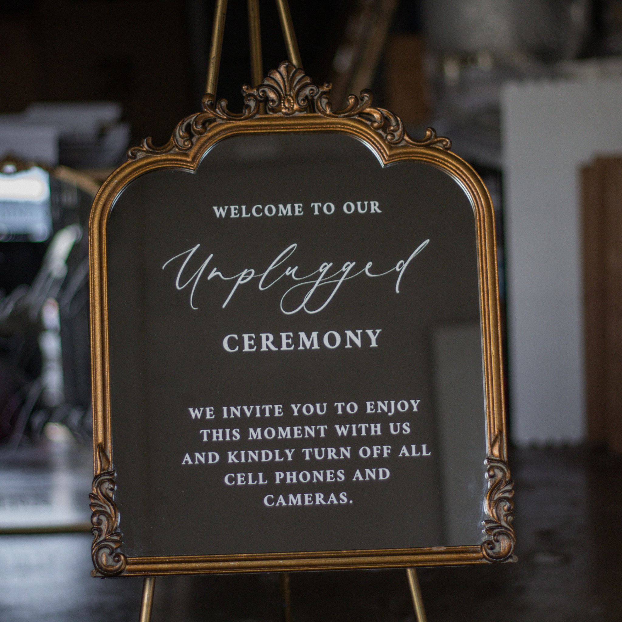 Unplugged Ceremony Signs on decorative wedding mirror asking guests to turn off phones.