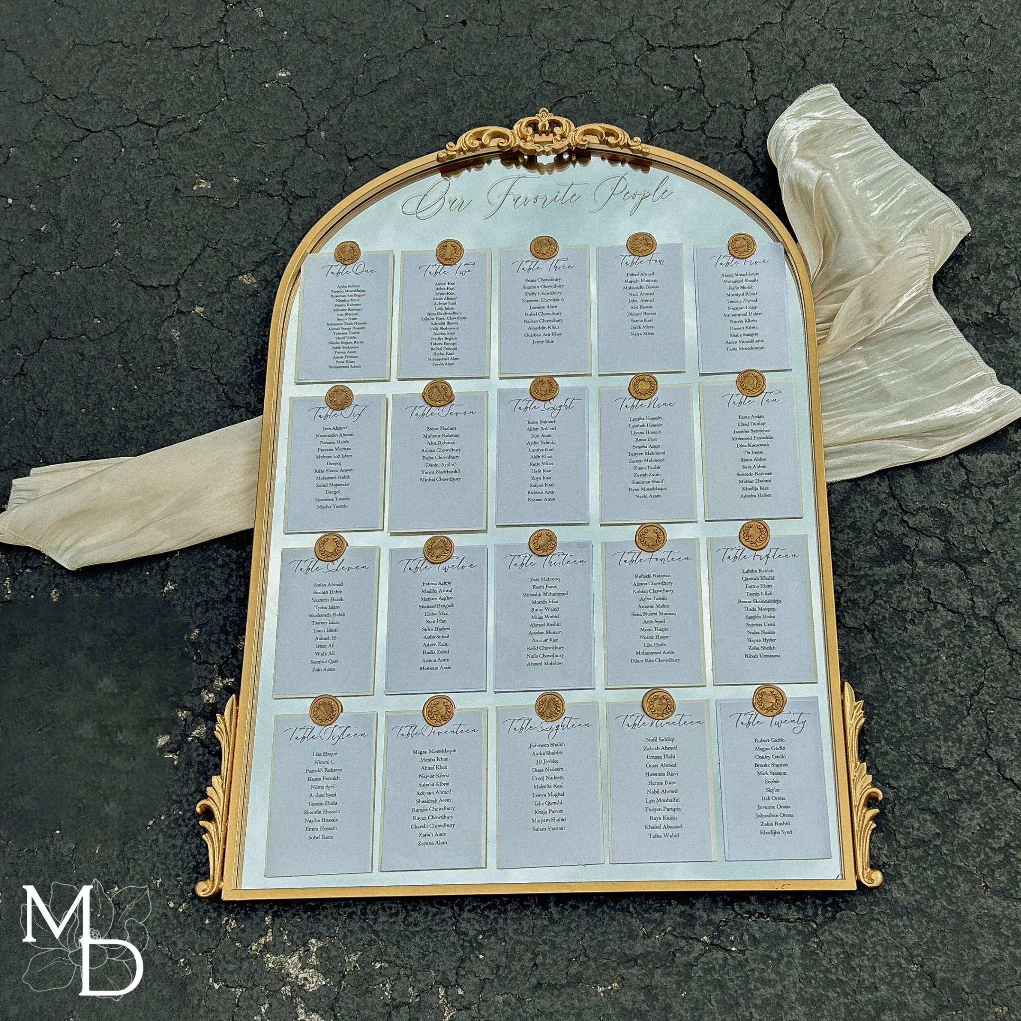 Elegant wedding guest table layout seating chart on arch mirror with customizable vinyl decal and wax seals.