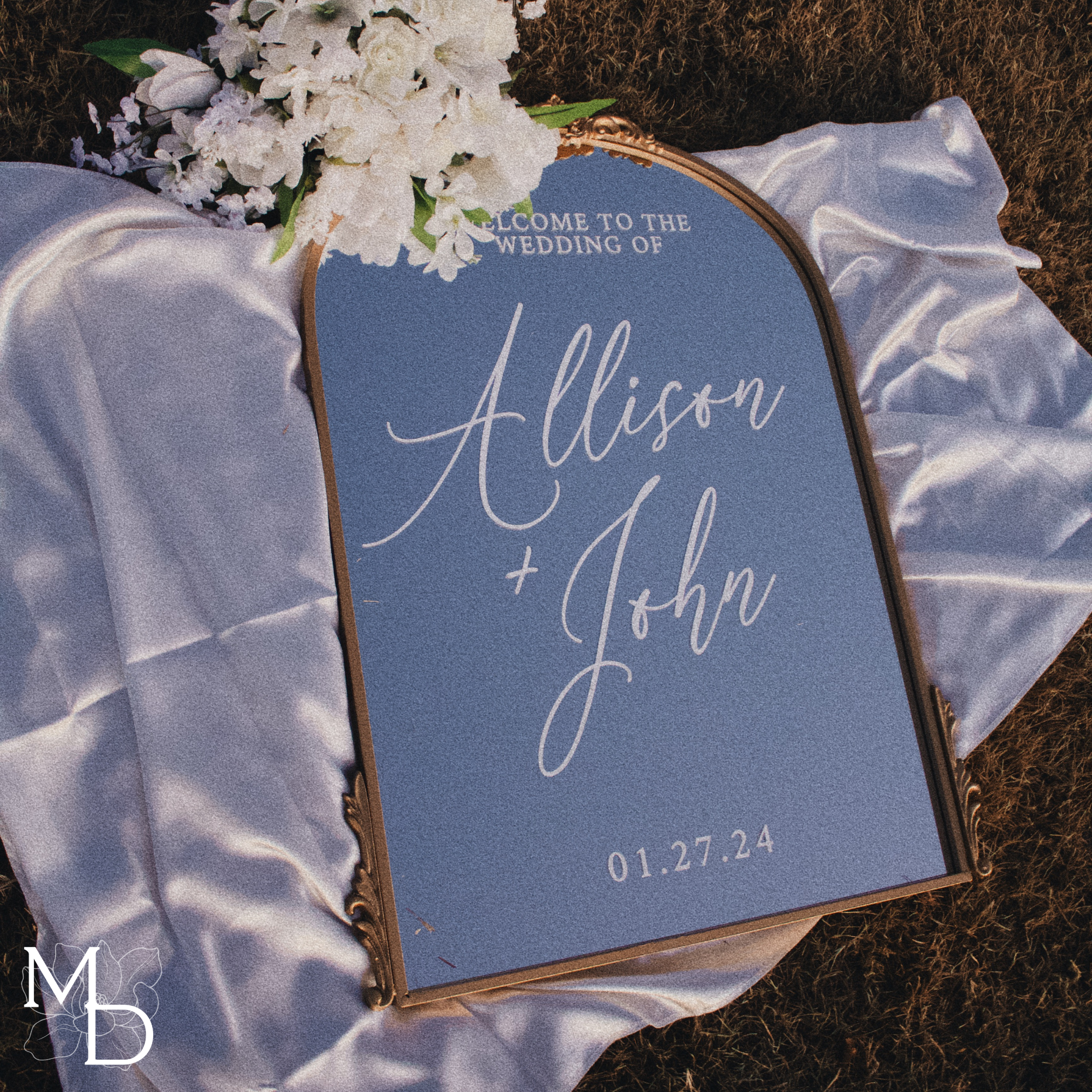 Antiqued gold arch wedding welcome mirror with custom scripted calligraphy.