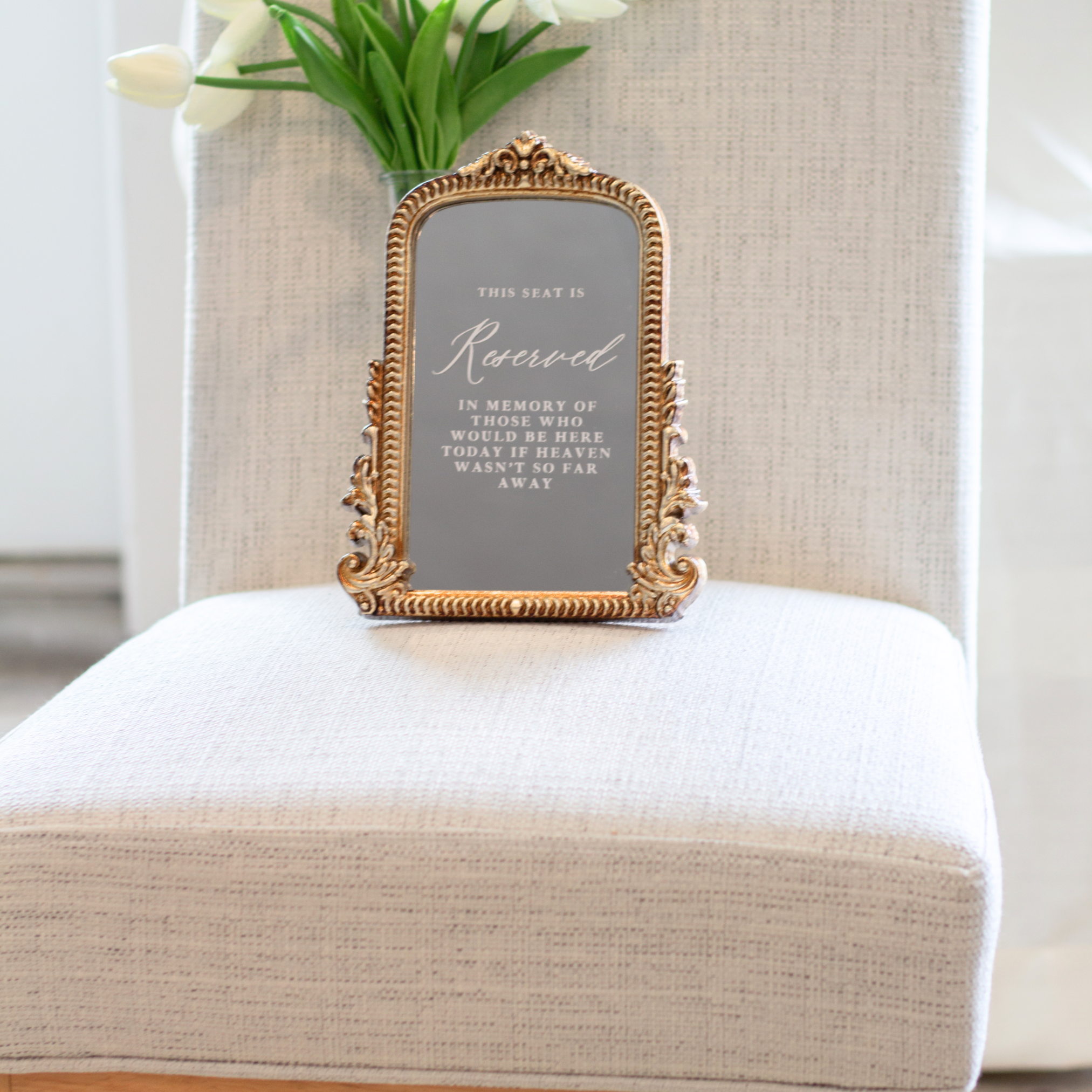 Loving Memory Wedding Sign with customizable message in ornate gold frame displayed on a chair.