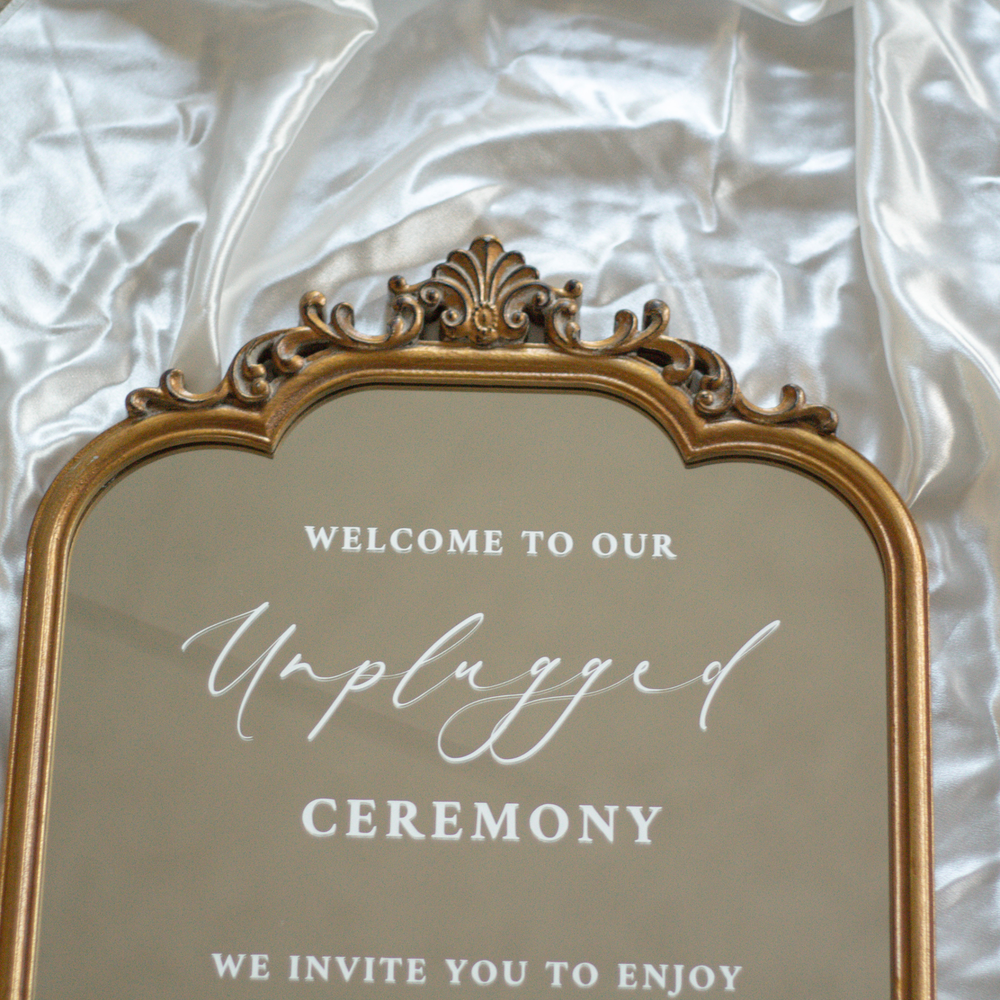 Elegant Unplugged Ceremony Sign on ornate wedding mirror with hand-lettered text for phone-free ceremony.