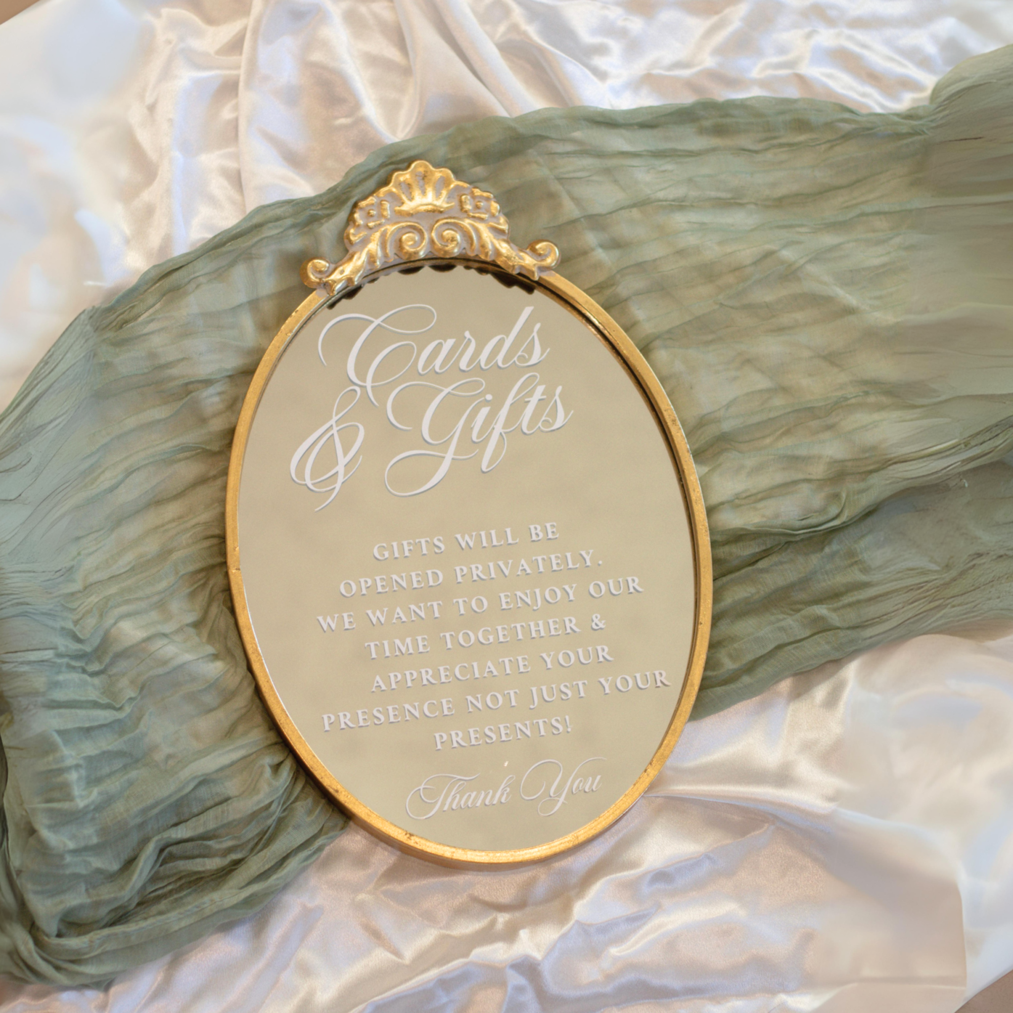 Elegant gold oval mirror wedding sign for cards and gifts table.