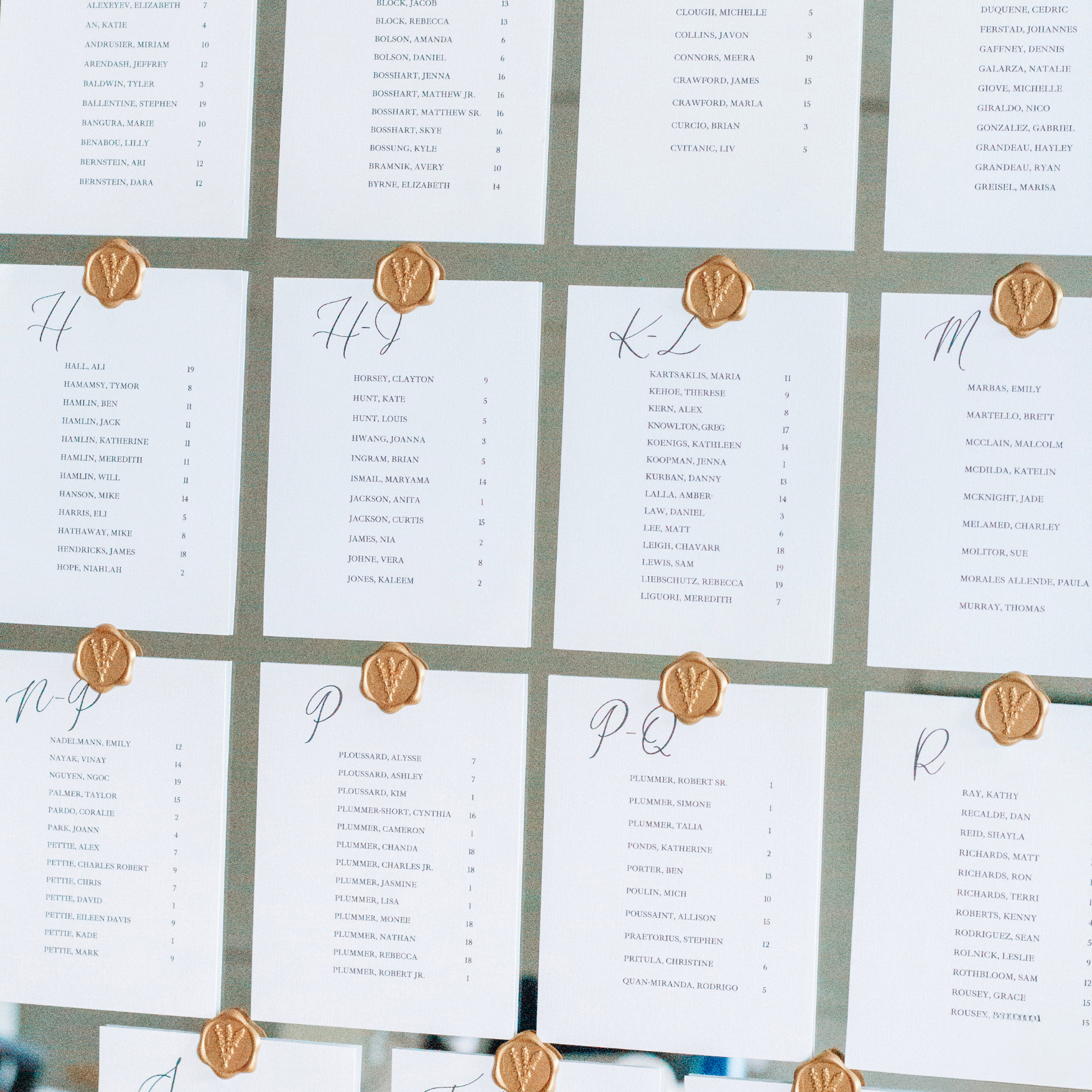 Elegant seating chart assignment cards with wax seals on linen cardstock for weddings.